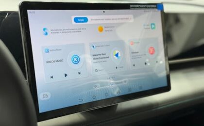 Modern car dashboard featuring a digital touchscreen interface with multiple apps.
